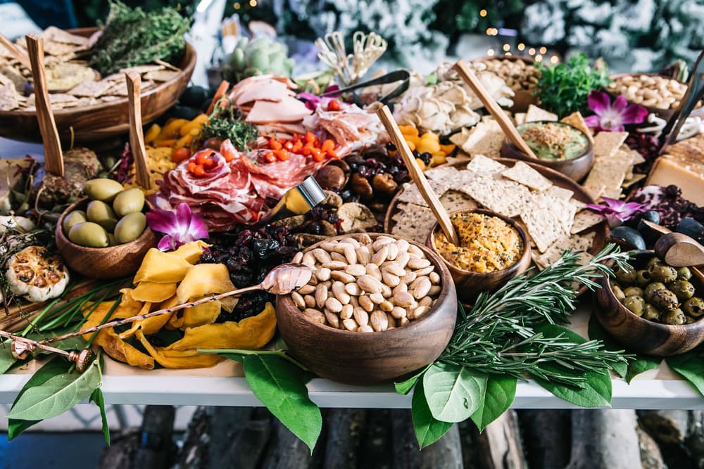 Table full of Blue Diamond Almonds, Nut Thins, and varied meats and snacks