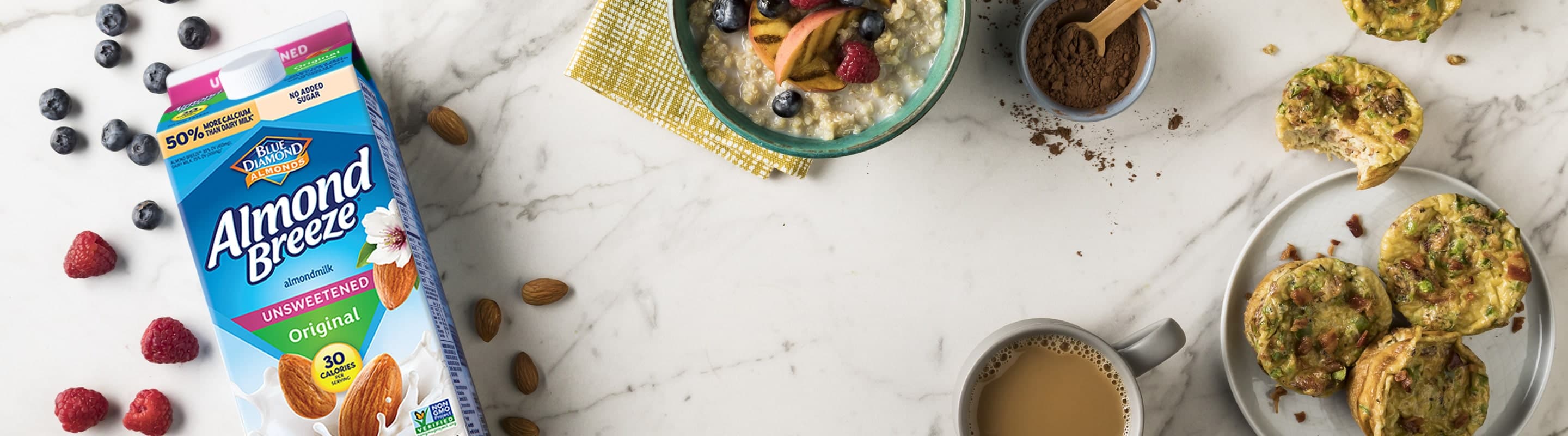 Counter top with bowl of oatmeal, mug of coffee, and a half gallon of Almond Breeze almondmilk